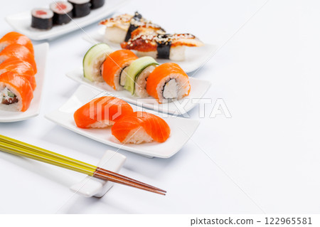Assorted sushi and maki rolls beautifully arranged on plates Assorted sushi and maki rolls beautifully arranged on plates 122965581