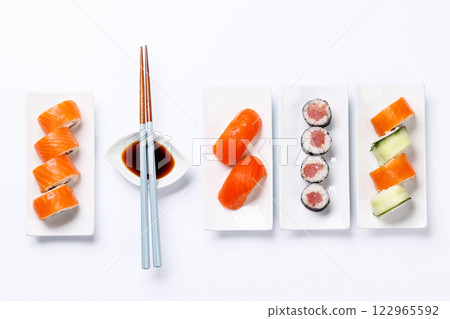 Assorted sushi and maki rolls beautifully arranged on plates 122965592
