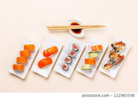 Assorted sushi and maki rolls beautifully arranged on plates 122965598