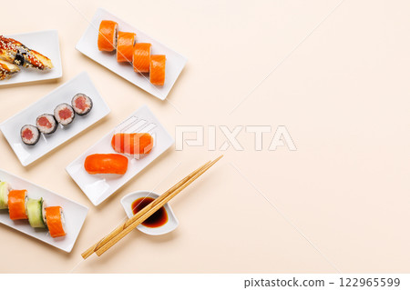 Assorted sushi and maki rolls beautifully arranged on plates Assorted sushi and maki rolls beautifully arranged on plates 122965599