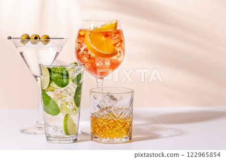 A vibrant display of cocktails, including Aperol Spritz, Mojito, and Martini A vibrant display of cocktails, including Aperol Spritz, Mojito, and Martini 122965854