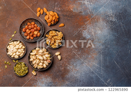 A vibrant assortment of various nuts, including almonds, walnuts, hazelnuts, cashews, and pistachios A vibrant assortment of various nuts, including almonds, walnuts, hazelnuts, cashews, and pistachios 122965890