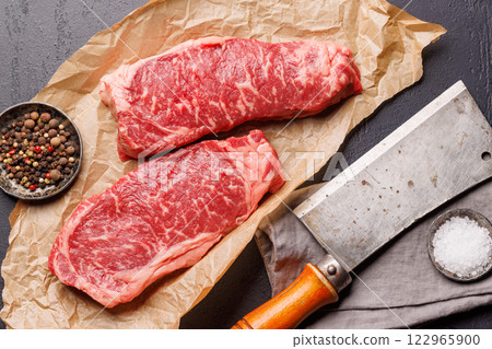 Raw marbled striploin steak, fresh, rich, ready for cooking Raw marbled striploin steak, fresh, rich, ready for cooking 122965900