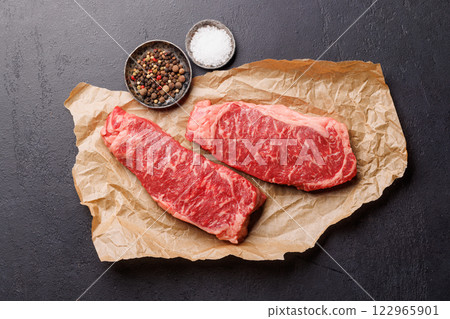 Raw marbled striploin steak, fresh, rich, ready for cooking Raw marbled striploin steak, fresh, rich, ready for cooking 122965901