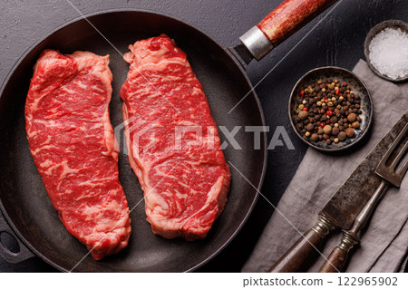 Raw marbled striploin steak, fresh, rich, ready for cooking Raw marbled striploin steak, fresh, rich, ready for cooking 122965902