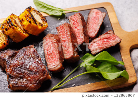 A perfectly cooked sliced striploin steak with a juicy, tender texture 122965907