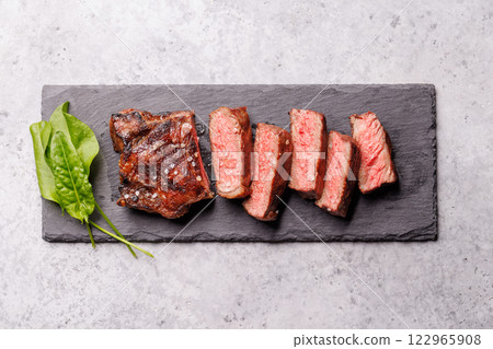 A perfectly cooked sliced striploin steak with a juicy, tender texture 122965908