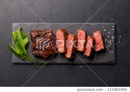 A perfectly cooked sliced striploin steak with a juicy, tender texture 122965909