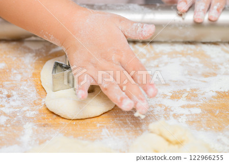 Girl's hands making homemade cookies 122966255