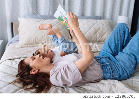 Mother reads a story daughter listens 122966703