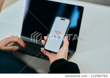 A young man in his 20s operating a smartphone NISAvsiDeCo A young man in his 20s operating a smartphone NISAvsiDeCo 122966769
