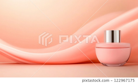 Elegant pink perfume bottle on a soft peach background with flowing satin fabric 122967175