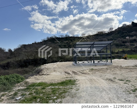 Metal construction, metal frame for building a house. New solutions for building construction. Construction in the mountains. Metal construction, metal frame for building a house. New solutions for building construction. Construction in the mountains. 122968167