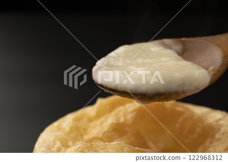 Pie stew: Lifting the pie-wrapped stew with a spoon Pie stew: Lifting the pie-wrapped stew with a spoon 122968312