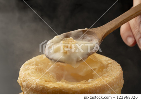 Pie stew: Lifting the pie-wrapped stew with a spoon 122968320