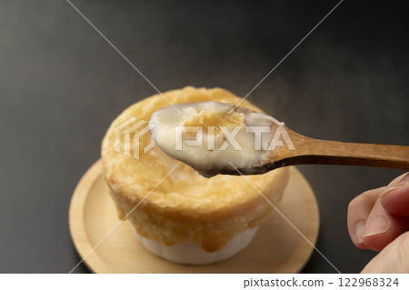 Pie stew: Lifting the pie-wrapped stew with a spoon Pie stew: Lifting the pie-wrapped stew with a spoon 122968324