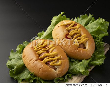 Hot Dog Product photo of a hot dog with lots of mustard 122968394