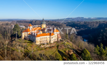 On a sunny day, Grabstejn castle stands majestically against a clear blue sky, surrounded by lush greenery and hills. Its historical architecture invites visitors to explore its rich heritage. On a sunny day, Grabstejn castle stands majestically against a clear blue sky, surrounded by lush greenery and hills. Its historical architecture invites visitors to explore its rich heritage. 122968456