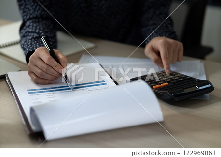 Young business woman is reading a document, checking the accuracy 122969061
