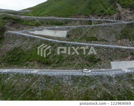 Aerial view of  winding road high altitude mountain landscape 122969069