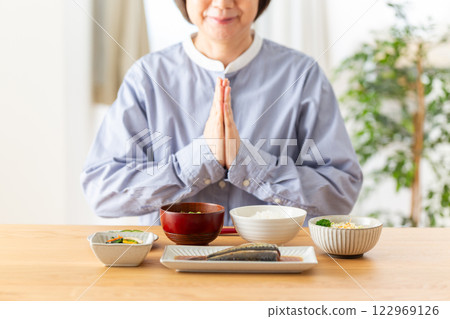 Middle-aged woman eating Japanese breakfast 122969126