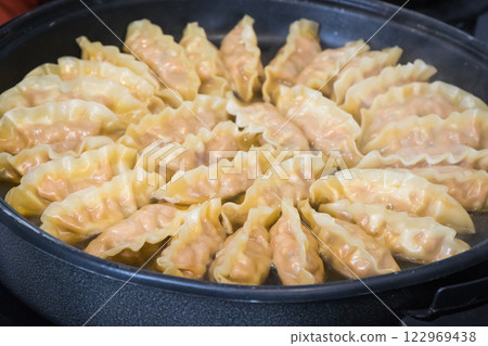 Fried dumplings on frying pan. Traditional food 122969438