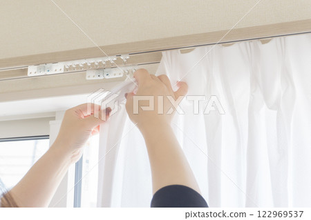 Installing curtains Installing curtains 122969537