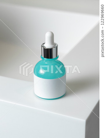 Dropper bottle with blank label on white basin close up, packaging mockup.  Natural serum or essence 122969660
