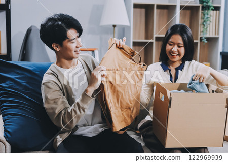 Smiling couple unpacking boxes in new house Smiling couple unpacking boxes in new house 122969939