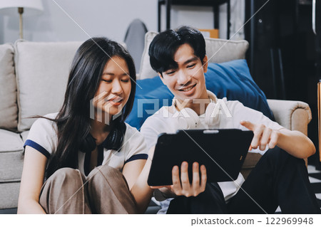 Smiling couple unpacking boxes in new house 122969948