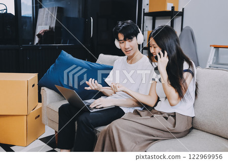 Smiling couple unpacking boxes in new house Smiling couple unpacking boxes in new house 122969956