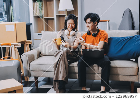 Smiling couple unpacking boxes in new house Smiling couple unpacking boxes in new house 122969957