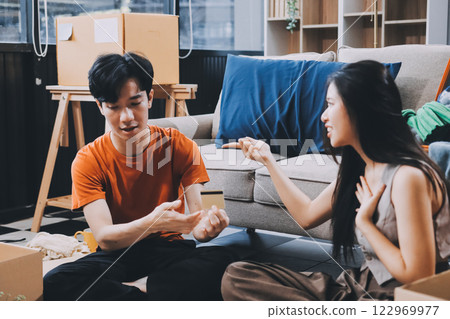 Young frustrated millennial couple sitting on couch at home, using computer and credit card. Buyers try to pay online have shortage of money on bank account. Extra expenses and big spender concept 122969977