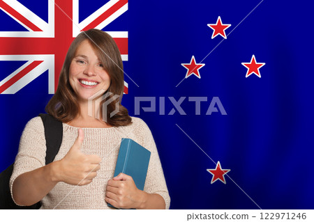 Successful woman student against New Zealand flag background. 122971246