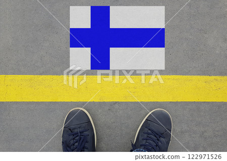 Word Start on an asphalt road with the Finnish flag and legs in shoes. Word Start on an asphalt road with the Finnish flag and legs in shoes. 122971526