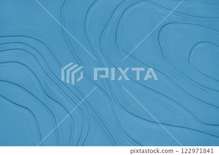 Plaster wall with volumetric relief surface with convex wavy lines, blue gypsum texture panel. Plaster wall with volumetric relief surface with convex wavy lines, blue gypsum texture panel. 122971841