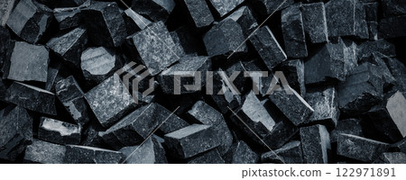 Black volcanic stone. Surface of basalt or granite close-up. Dark rough and textured rock. Black volcanic stone. Surface of basalt or granite close-up. Dark rough and textured rock. 122971891
