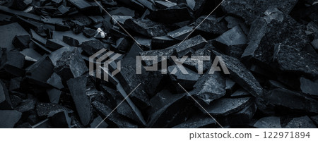 Black volcanic stone. Surface of basalt or granite close-up. Dark rough and textured rock. 122971894