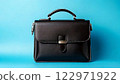 Black business bag on a light blue background 122971922