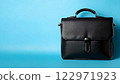 Black business bag on light blue background/copy space 122971923