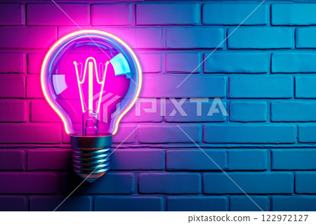 A neon light bulb on a brick wall 122972127
