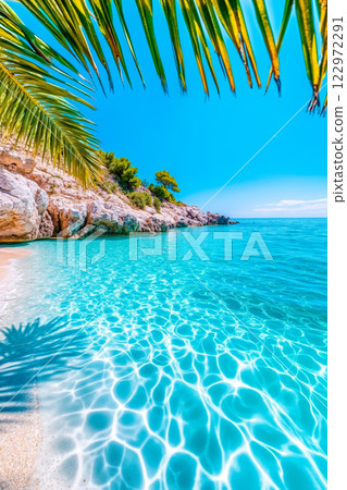 A view of a beach with clear blue water and a palm tree 122972291