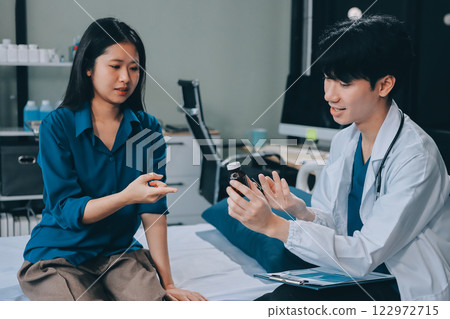doctor consulting senior old patient filling form at consultation. Professional physician wearing white coat talking to mature woman signing medical paper at appointment visit in clinic. 122972715