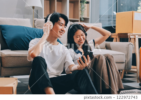 Smiling couple unpacking boxes in new house Smiling couple unpacking boxes in new house 122972743