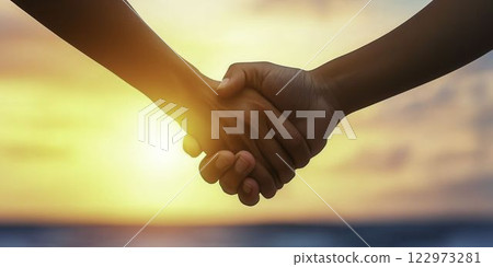 Senior Couple Holding Hands While Walking Along the Beach at Sunset 122973281