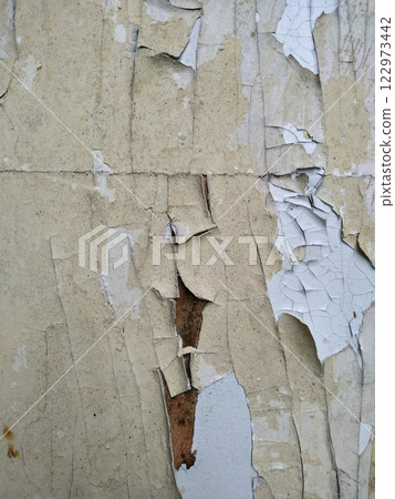 Peeling paint on the wall. Old concrete wall with cracked flaking paint. Weathered rough painted surface with patterns of cracks and peeling. Grunge texture for background and design. High resolution Peeling paint on the wall. Old concrete wall with cracked flaking paint. Weathered rough painted surface with patterns of cracks and peeling. Grunge texture for background and design. High resolution 122973442