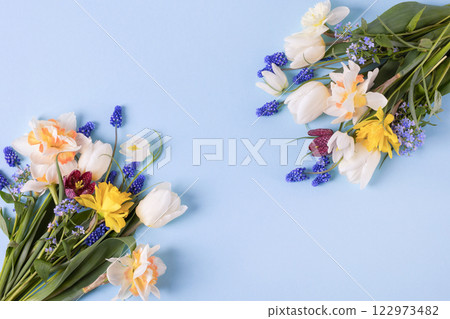 Spring composition on a blue background of flowers of tulips, muscari, daffodils, grouse with a place for text. Happy Mother's Day greeting card, happy Valentine's Day, March 8th, happy birthday 122973482