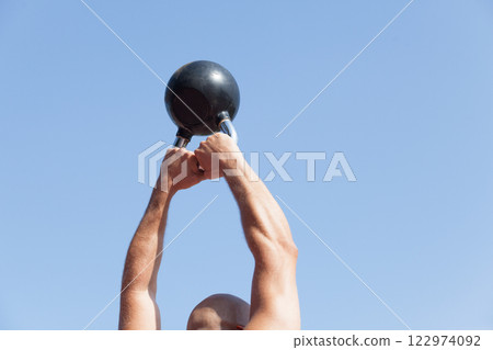 Exercising with a kettlebell 122974092