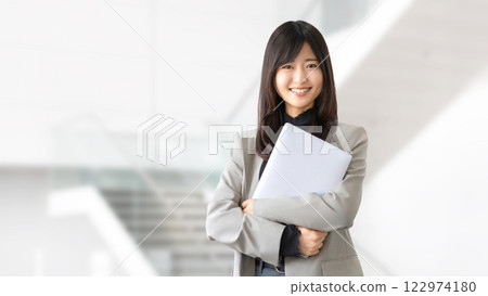 Smiling woman/businesswoman with a laptop 122974180