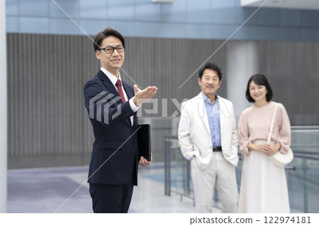 A salesman showing a couple in their 50s around 122974181